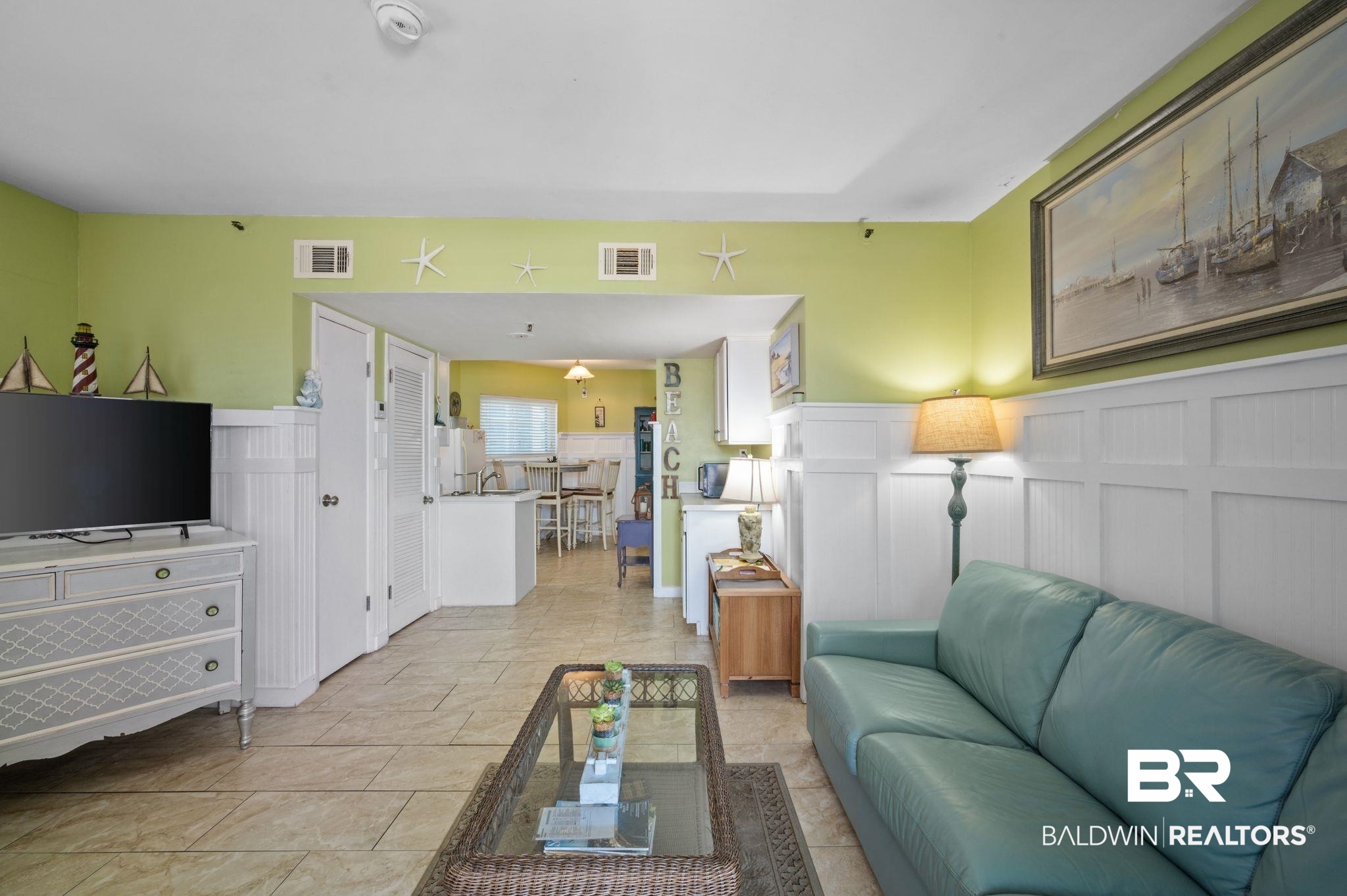 375 Plantation Road, Unit 5304 Gulf Shores, AL 36542 - Photo 7 of 42 Living area with wainscoting and a decorative wall