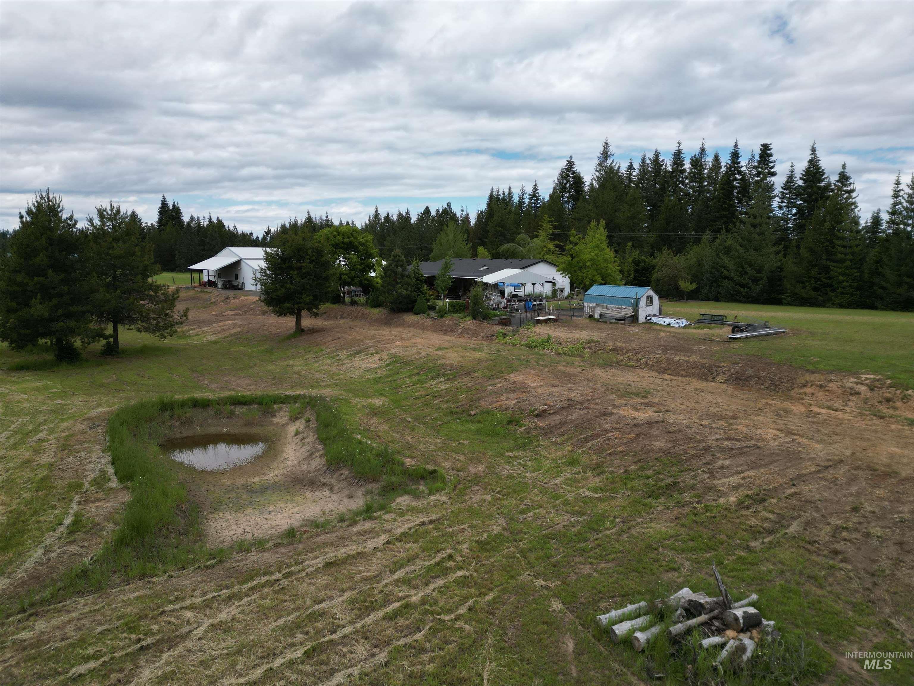 254 Lackey Road Weippe, ID 83553 - Photo 29 of 38 Expansive property with a white barn-style outbuilding, a single-story residence, and a blue storage shed