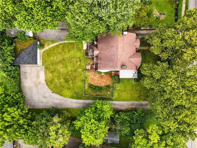 an aerial view of a house with a yard and a fountain