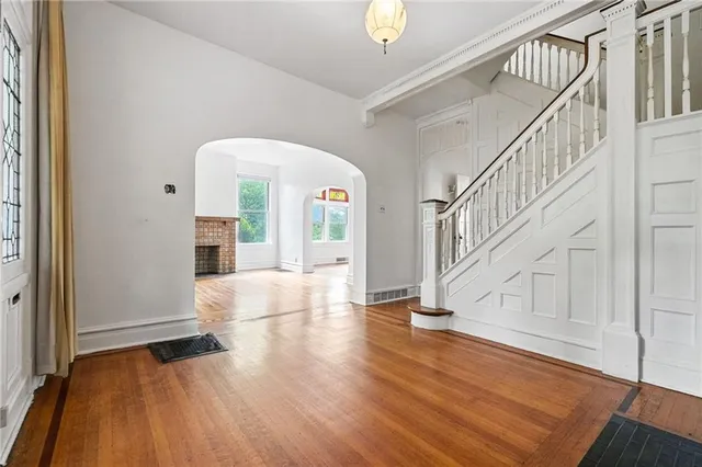 a view of entryway and hall with wooden floor