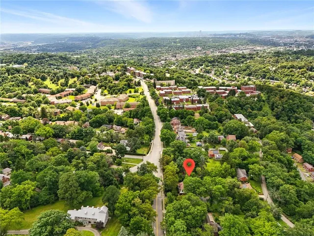 an aerial view of residential building with an outdoor space and seating