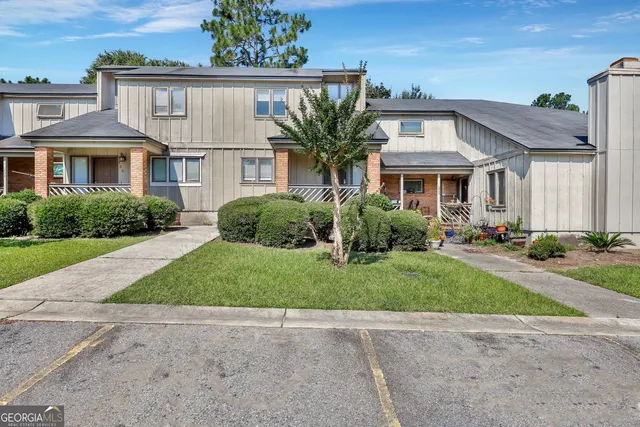 a front view of a house with garden