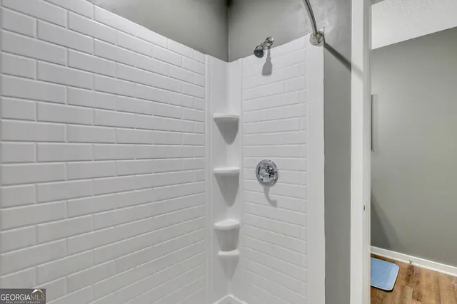 a bathroom with a toilet and a shower