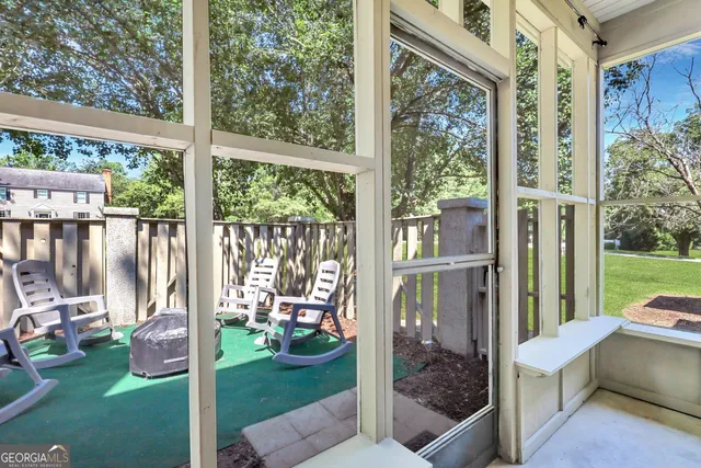 a view of a porch with furniture and garden