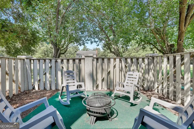 a view of a chair and table in backyard