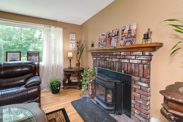 11 Glenmere Road Charlton, MA 01507 - Photo 15 of 30 a living room with furniture a fireplace and a floor to ceiling window