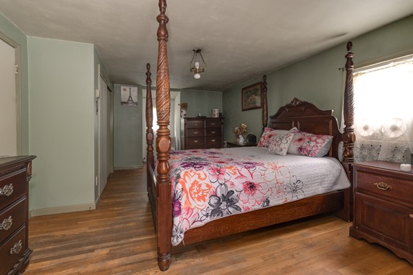 11 Glenmere Road Charlton, MA 01507 - Photo 21 of 30 a bedroom with a large bed and a chandelier
