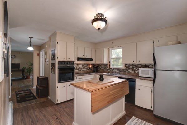 11 Glenmere Road Charlton, MA 01507 - Photo 3 of 30 a kitchen with a refrigerator a stove top oven a sink dishwasher and white cabinets with wooden floor