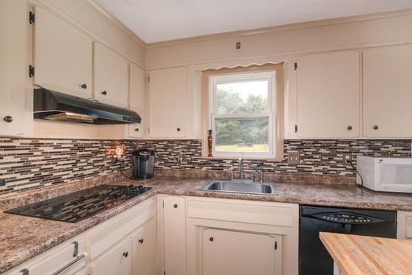 11 Glenmere Road Charlton, MA 01507 - Photo 5 of 30 a kitchen with granite countertop a sink a stove and cabinets