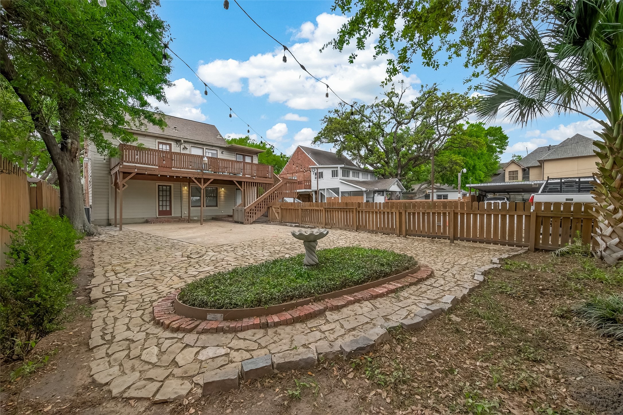 1807 Crocker Street, Unit A Houston, TX 77006 - Photo 33 of 37 Overall view of the back of the property and driveway/parking area. Landlord takes care of the lawn maintenance for this double-duplex community.