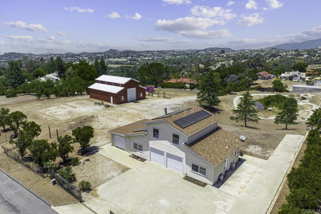 30402 Cool Valley Highlands Road Valley Center, CA 92082 - Photo 1 of 1 an aerial view of a house with a garden and lake view