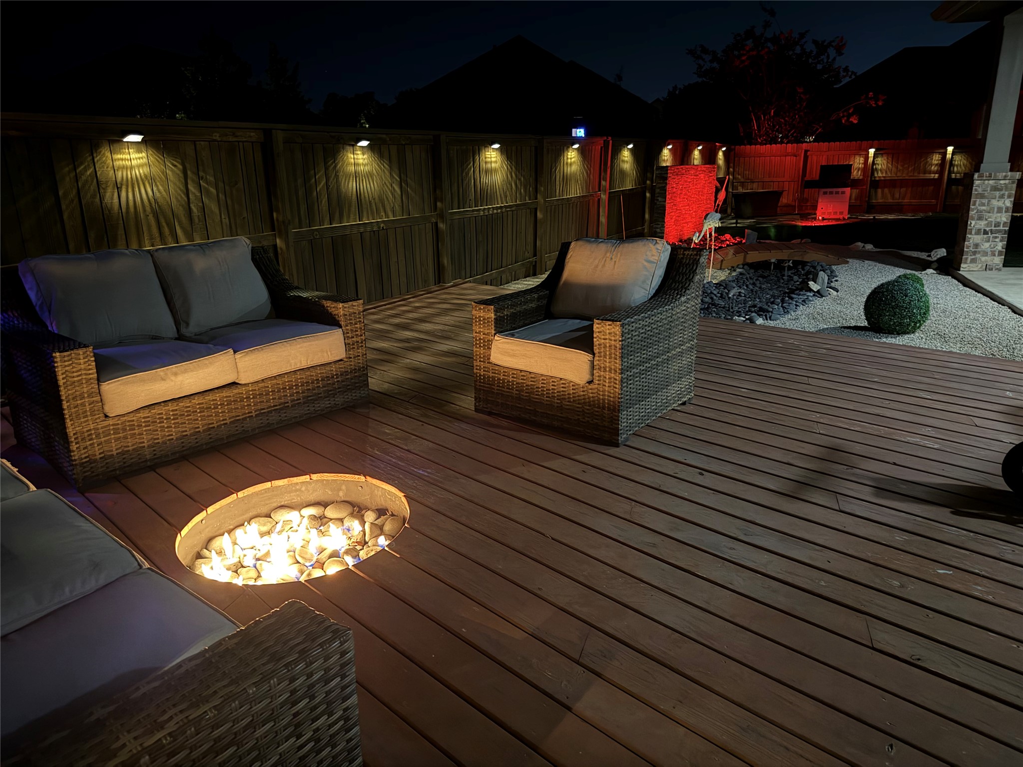 12616 Twisted Root Drive Manchaca, TX 78652 - Photo 34 of 36 At night the backyard comes alive with the custom fire pit being the perfect place the unwind at the end of a long day.