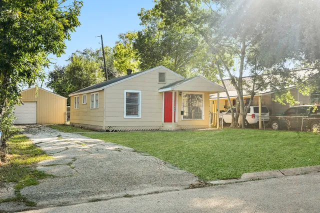 a front view of a house with a garden