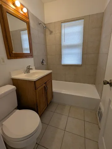 a bathroom with a sink a toilet and mirror