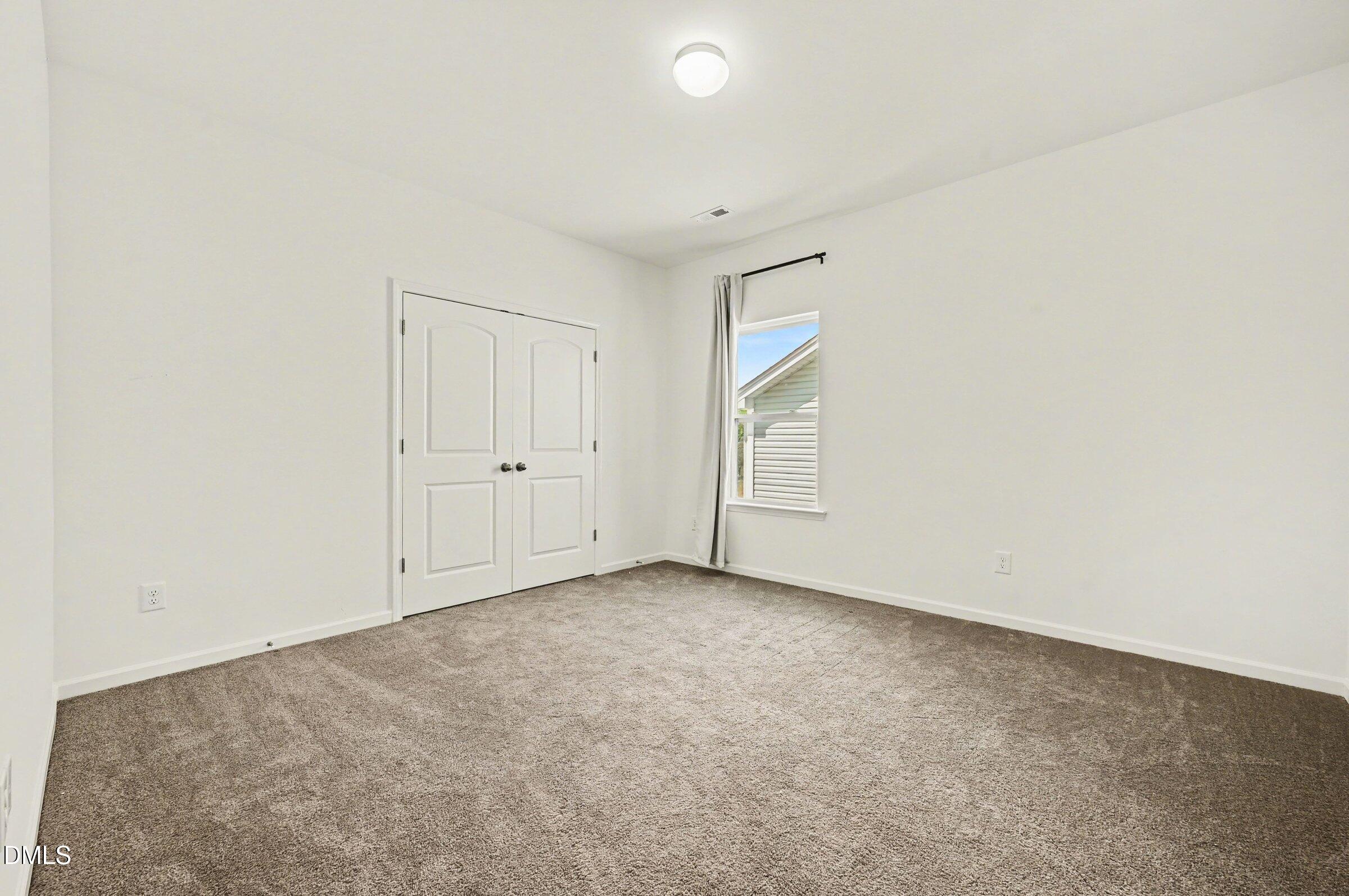 7015 Grainfield Road Mebane, NC 27302 - Photo 25 of 42 an empty room with white cabinet and windows