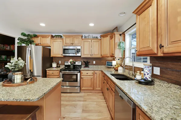 a living room with furniture and kitchen view