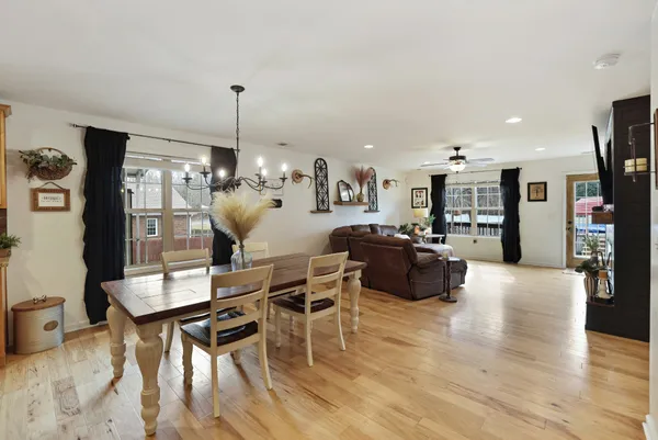 a kitchen with kitchen island granite countertop a table and chairs in it