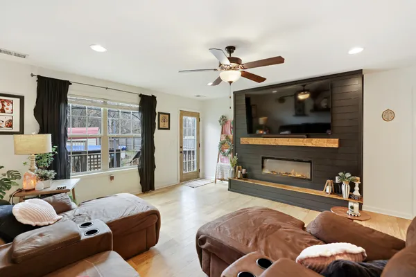 a living room with furniture and kitchen view