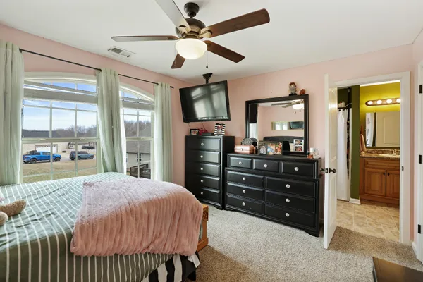 a living room with a bed and a flat screen tv