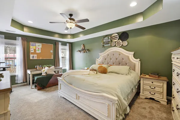 a bedroom with a bed and a chandelier