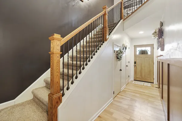 a view of a hallway with a door and a mirror