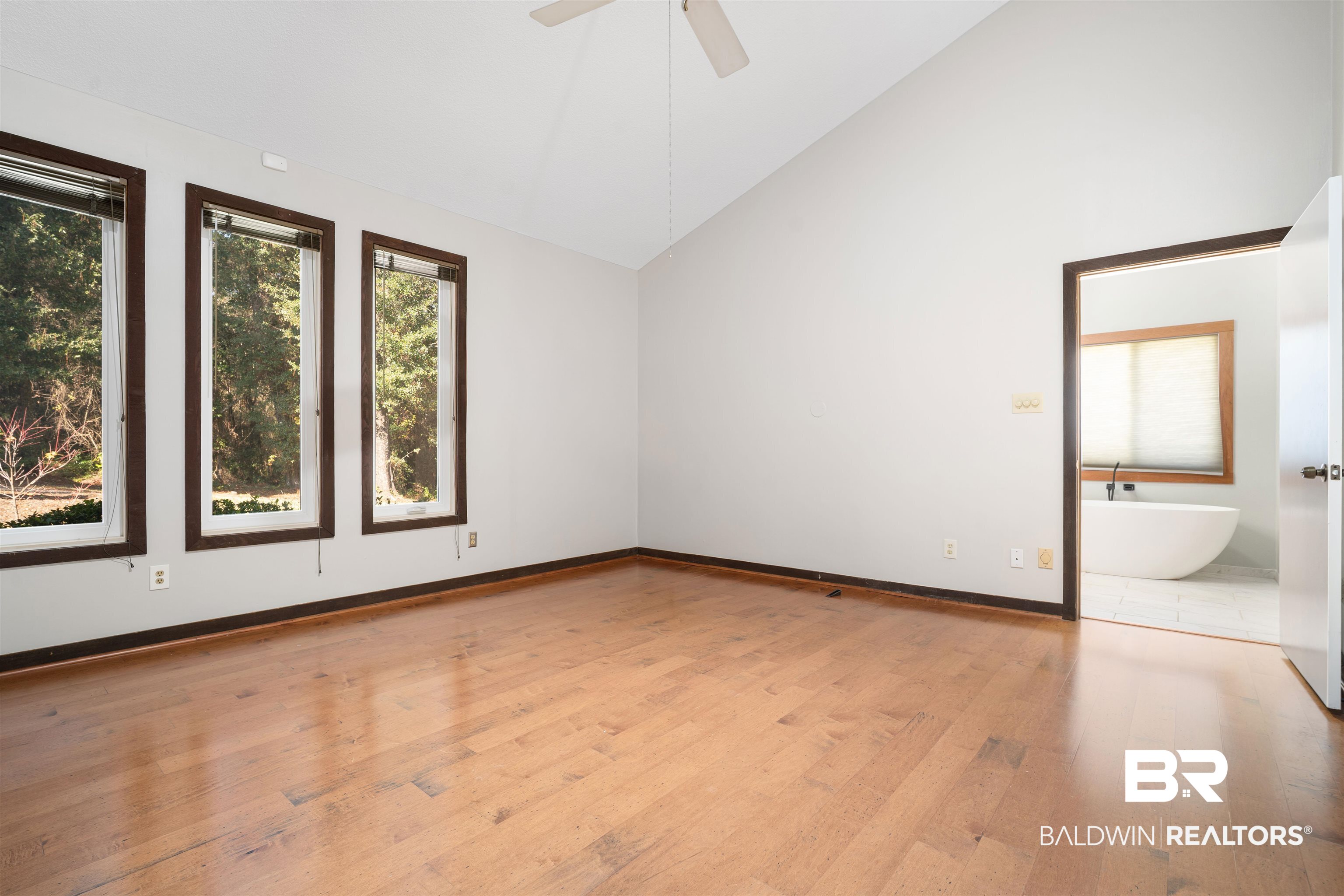 7912 Yorkhaven Road Mobile, AL 36695 - Photo 17 of 41 Empty room with light wood-type flooring, high vaulted ceiling, and ceiling fan