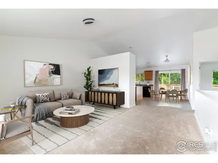 a living room with furniture a rug and a flat screen tv