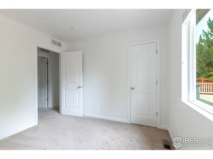 a view of an empty room and a window