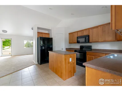 a kitchen with stainless steel appliances granite countertop a refrigerator and a stove