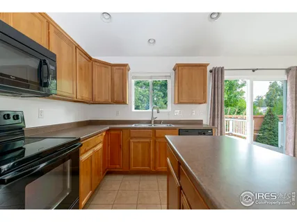 a kitchen with stainless steel appliances a sink dishwasher stove microwave and cabinets