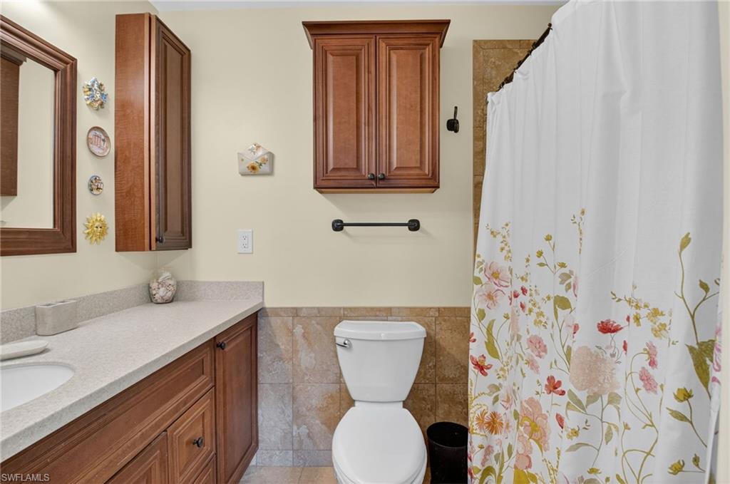 572 High Point Drive, Unit D Delray Beach, FL 33445 - Photo 15 of 21 a bathroom with a sink and a mirror