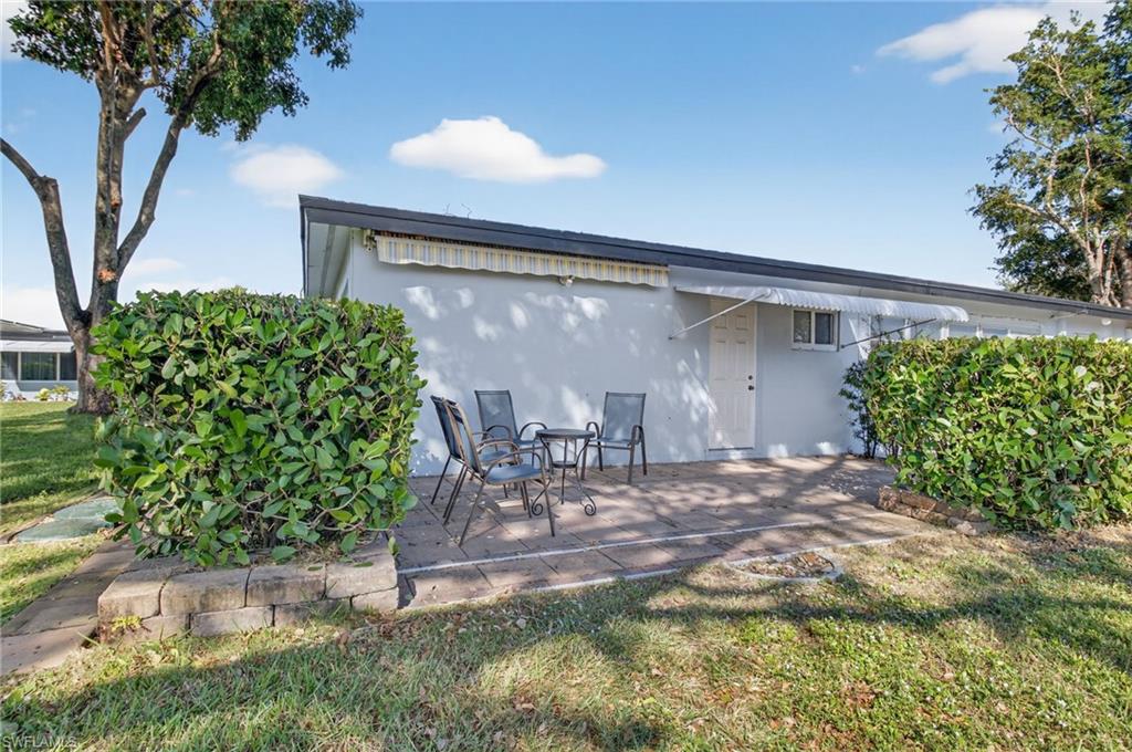 572 High Point Drive, Unit D Delray Beach, FL 33445 - Photo 16 of 21 a front view of a house with garden