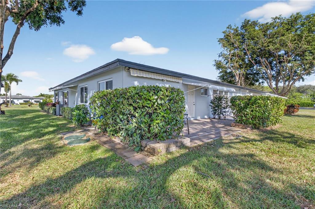 572 High Point Drive, Unit D Delray Beach, FL 33445 - Photo 18 of 21 a front view of a house with garden