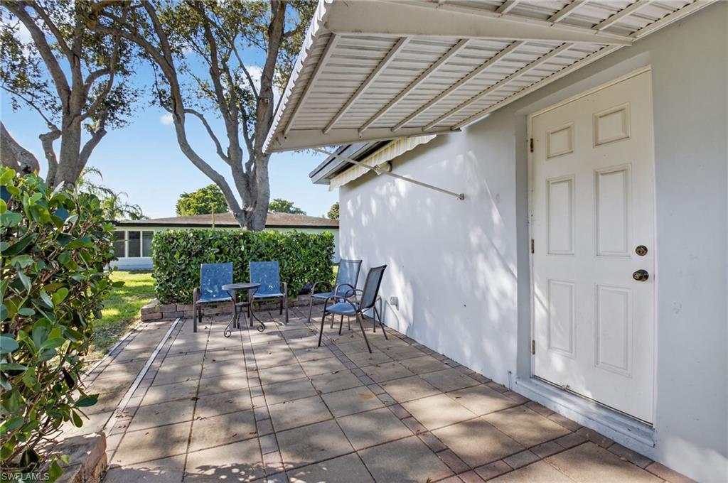 572 High Point Drive, Unit D Delray Beach, FL 33445 - Photo 2 of 21 a view of patio with table and chairs and potted plants
