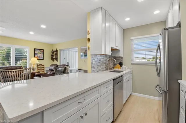 a kitchen with stainless steel appliances kitchen island granite countertop a sink and cabinets
