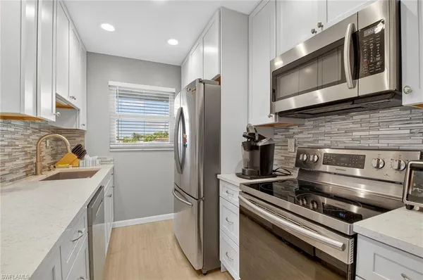 a kitchen with counter top space cabinets and stainless steel appliances
