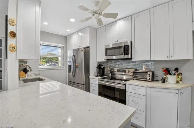 a kitchen with a dining table chairs refrigerator and cabinets