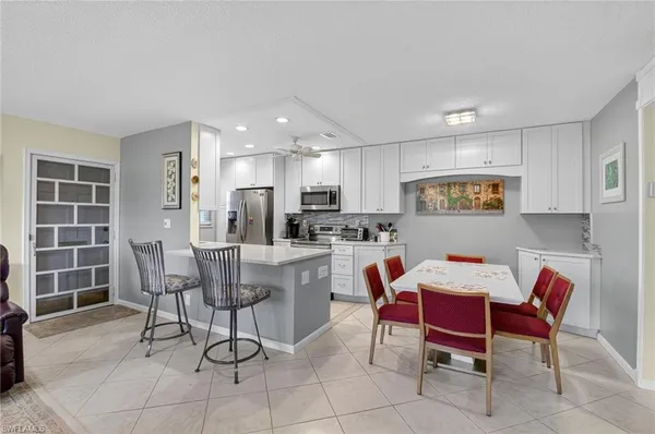 a kitchen with a refrigerator a stove a sink and a microwave