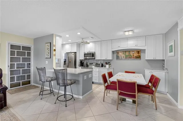 a kitchen with a refrigerator a stove a sink and a microwave