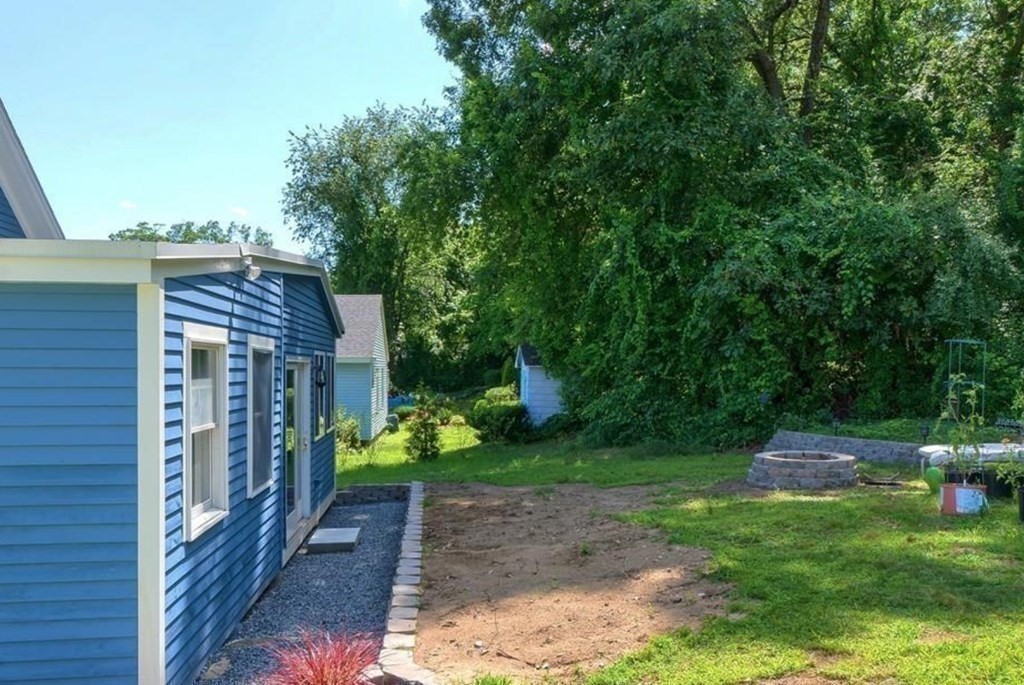 142 East Meadow Road Lowell, MA 01854 - Photo 27 of 28 a backyard of a house with lots of green space