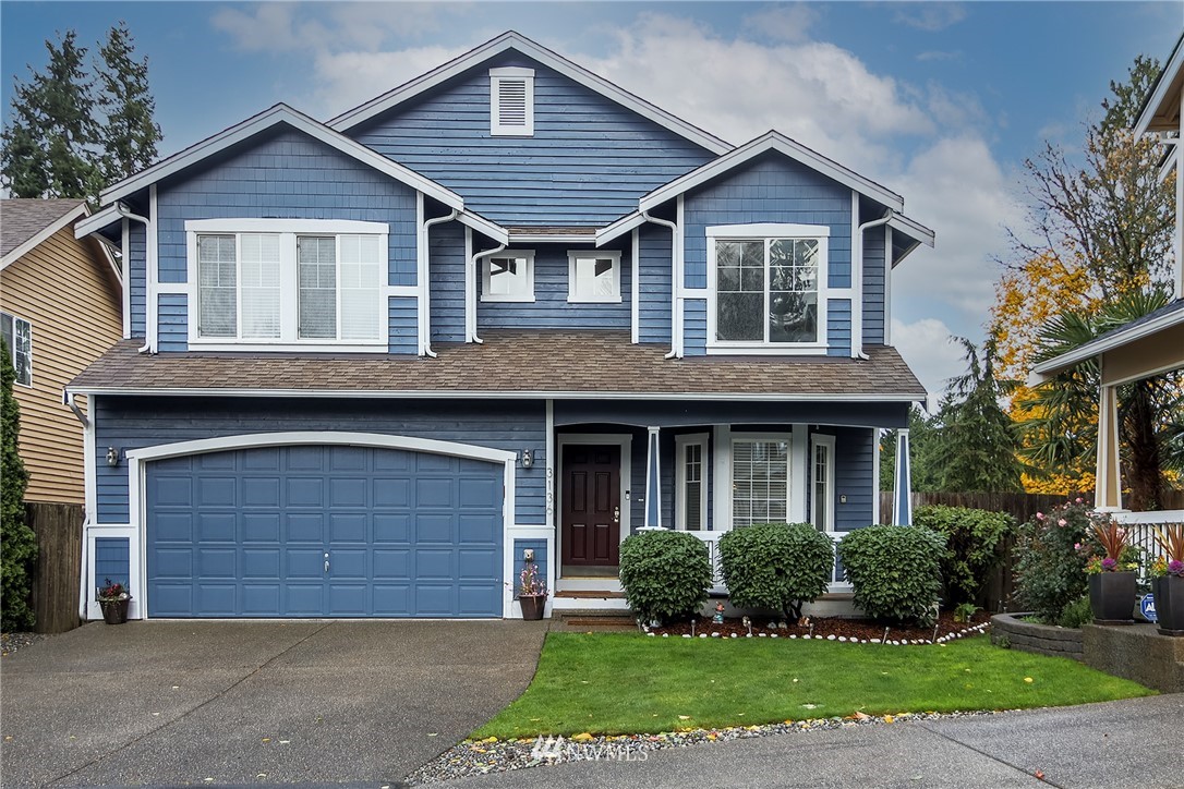 3136 Northeast 20th Place Renton, WA 98056 - Photo 1 of 29 a front view of a house with a yard and garage