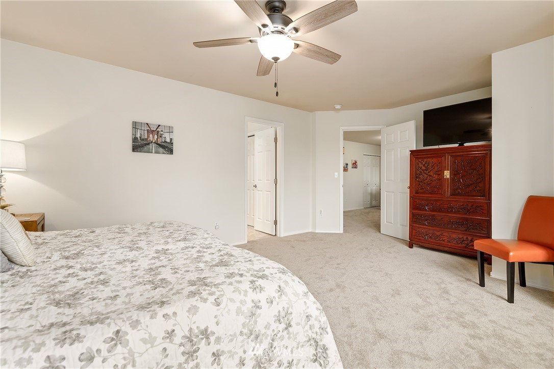 3136 Northeast 20th Place Renton, WA 98056 - Photo 18 of 29 a bedroom with a bed and a chandelier