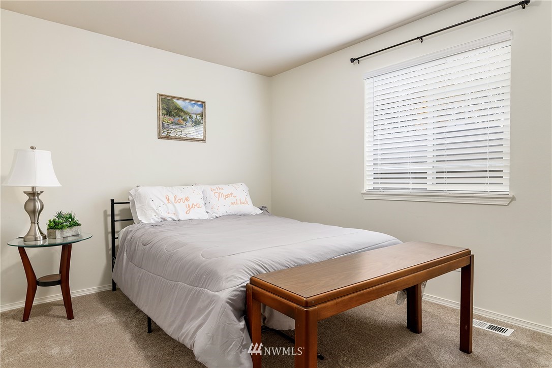 3136 Northeast 20th Place Renton, WA 98056 - Photo 22 of 29 a bedroom with a bed and a lamp on table