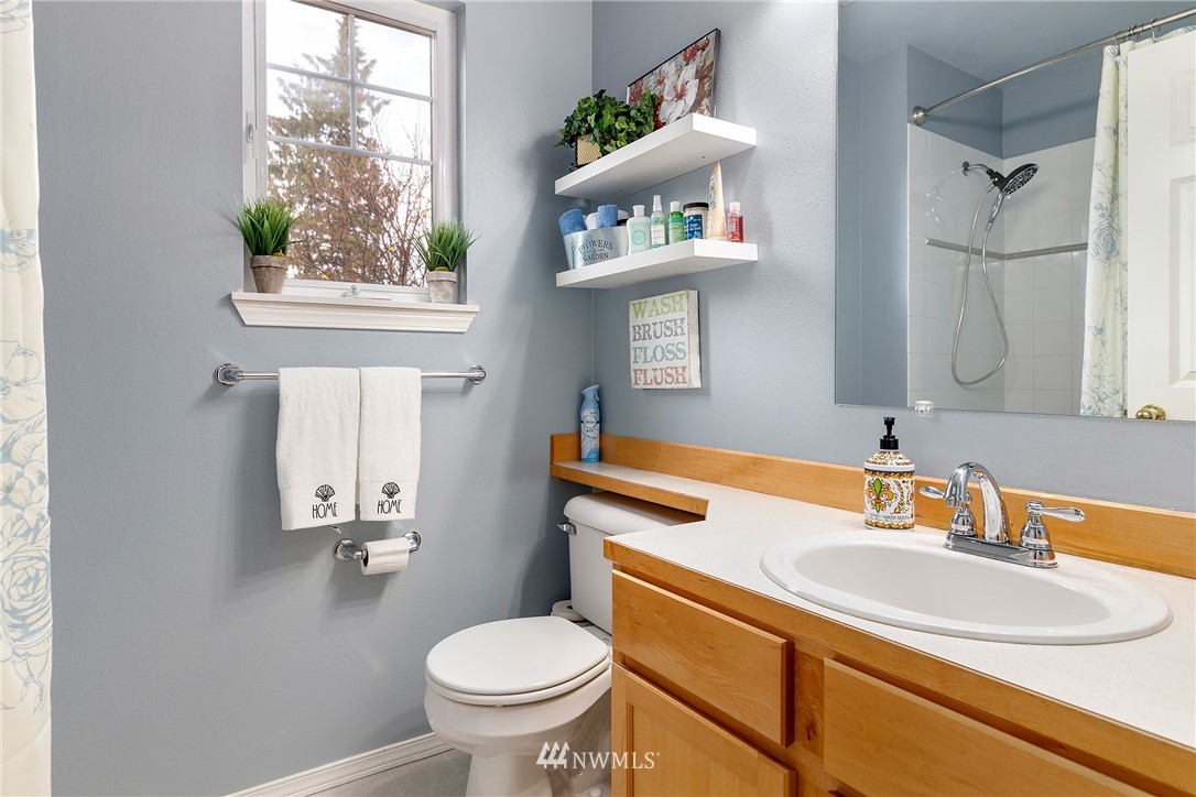 3136 Northeast 20th Place Renton, WA 98056 - Photo 23 of 29 a bathroom with a sink toilet and a mirror