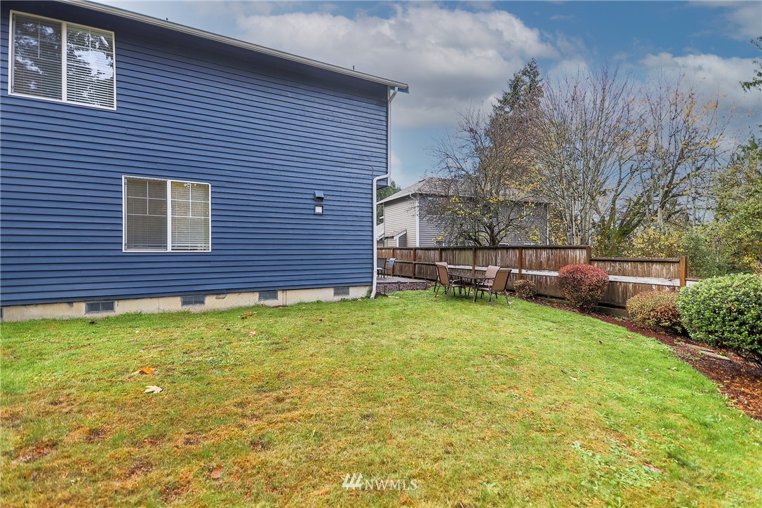 3136 Northeast 20th Place Renton, WA 98056 - Photo 28 of 29 a view of a backyard with plants and brick wall