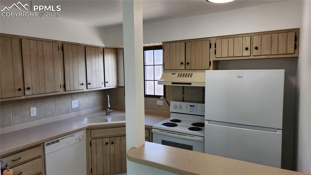 2007 Mohawk Road Pueblo, CO 81001 - Photo 11 of 19 a kitchen with a refrigerator sink and cabinets