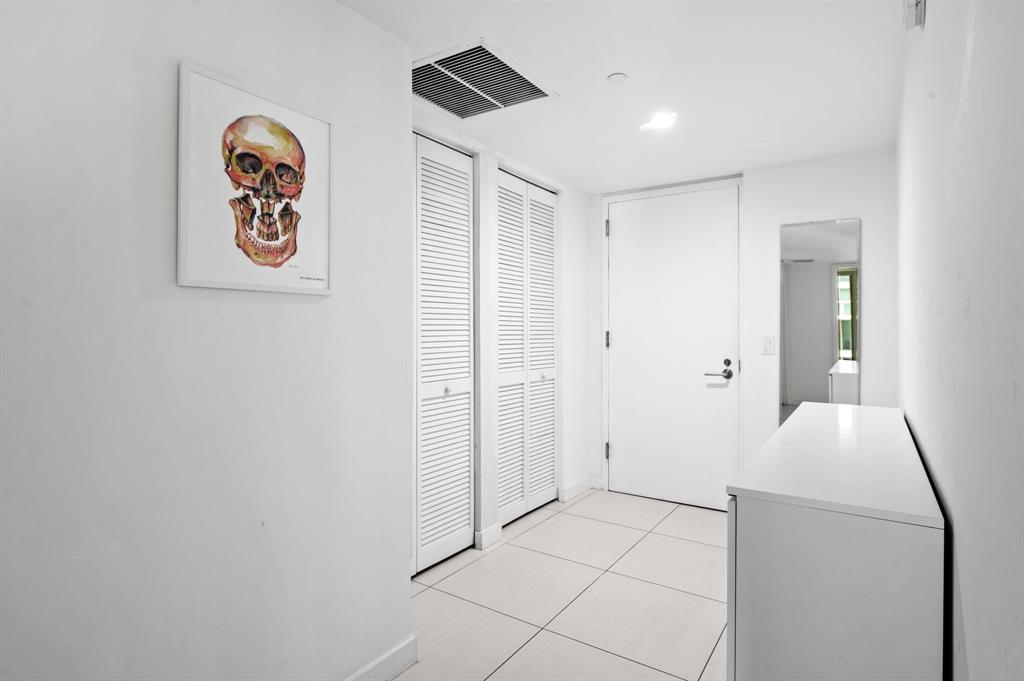 31 Southeast 6th Street, Unit 2002 Miami, FL 33131 - Photo 12 of 24 a view of room with window and wooden floor