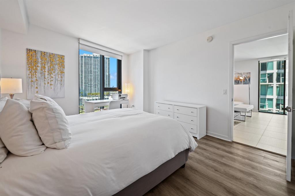 31 Southeast 6th Street, Unit 2002 Miami, FL 33131 - Photo 7 of 24 a large white bed in a white room