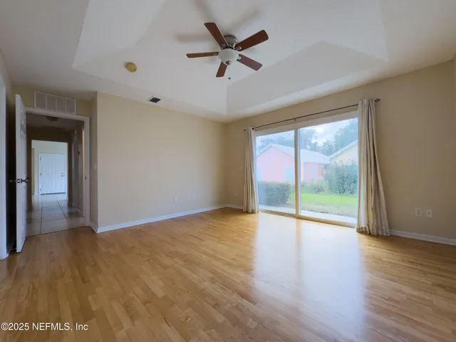 wooden floor in an empty room with a window