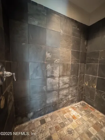 a bathroom with a tub a double vanity sink and mirror